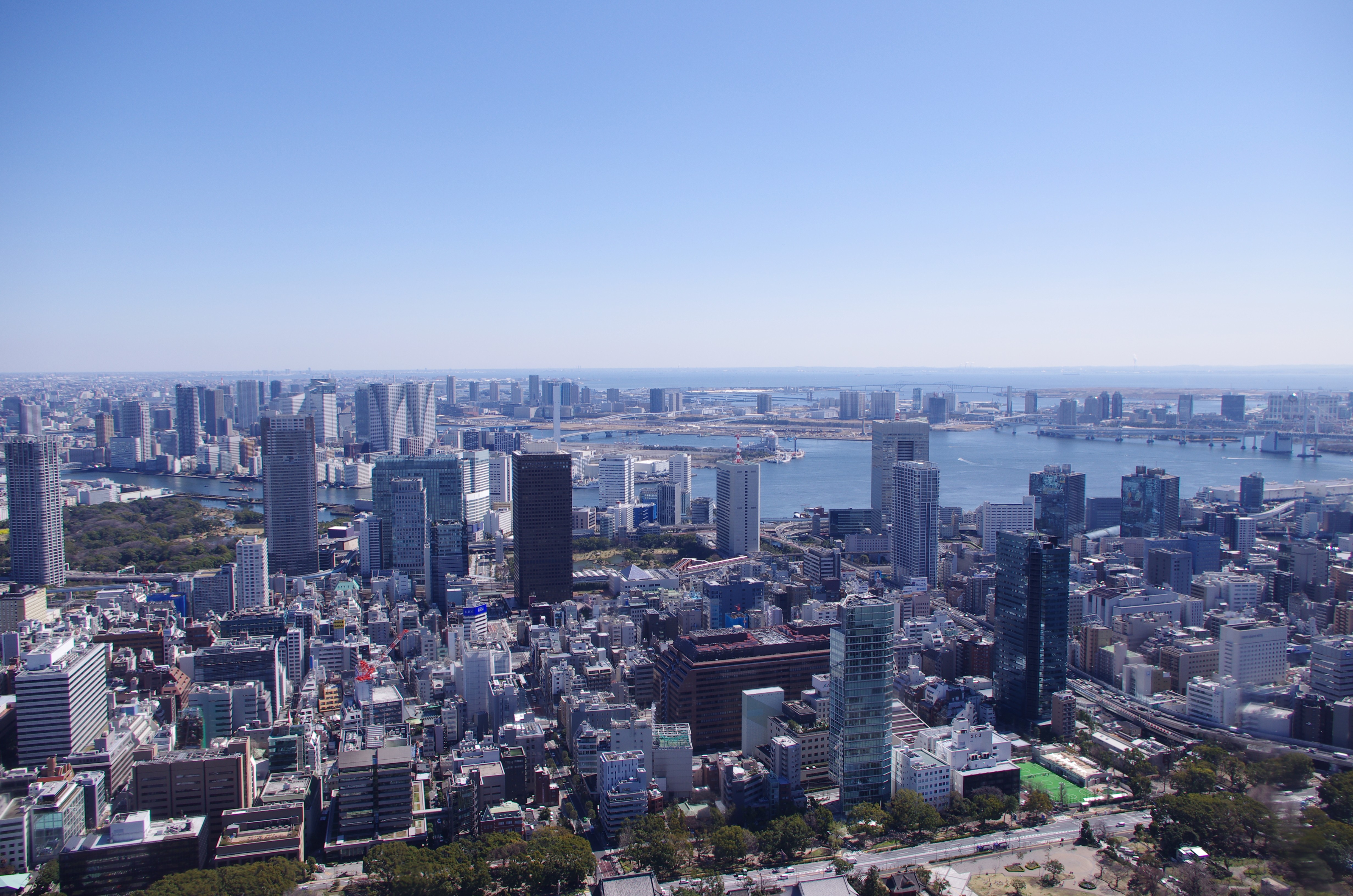 A view from Tokyo Tower, Odaiba in the background and part of Tokyo Bay with Rainbow Bridge